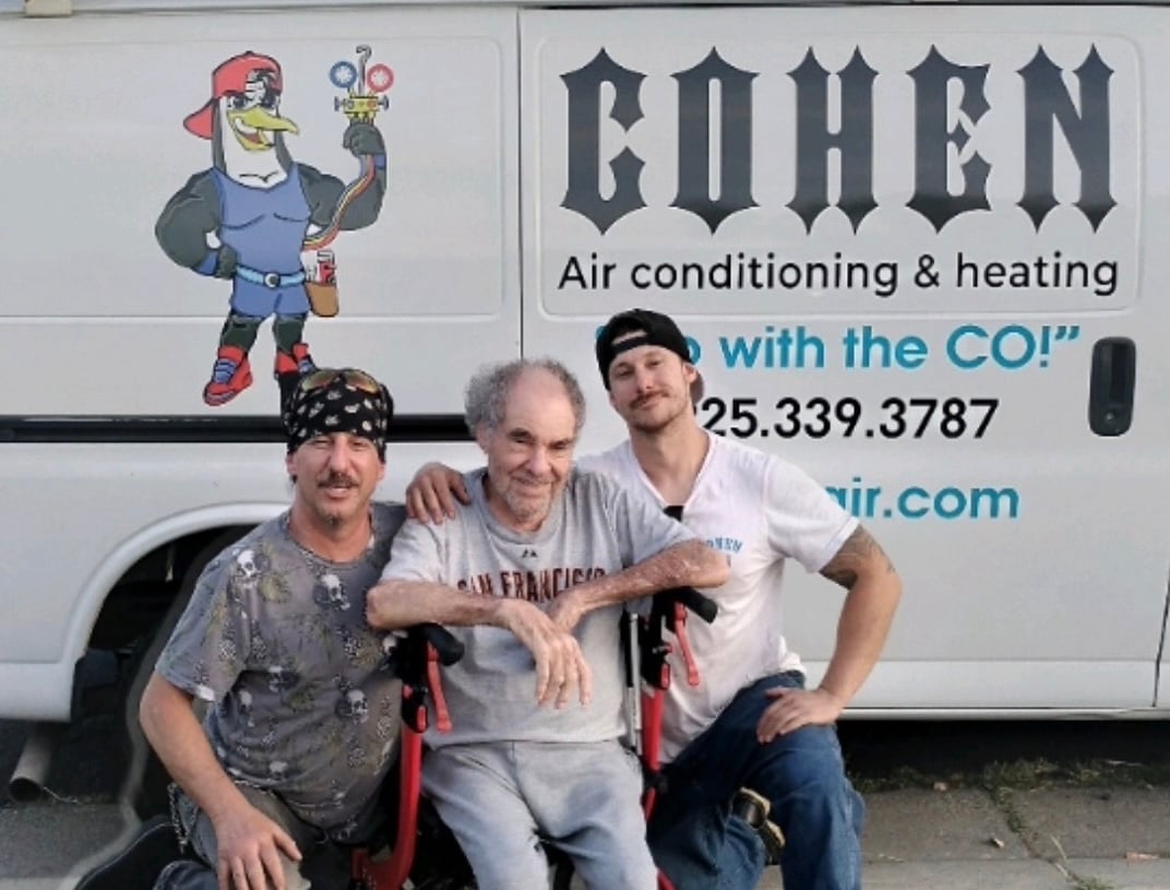 Three generations of the Cohen family in front of the Cohen Air van